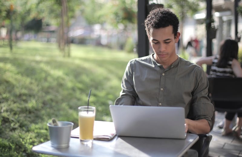 Freelancer working on laptop at a street cafe in Colombia