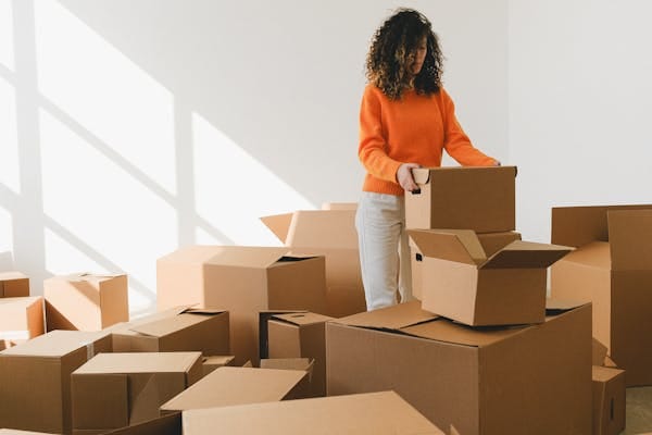 Person packing boxes before moving — the expat moving experience
