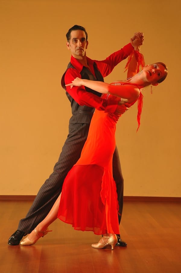 Salsa dancing couple performing classic moves, the heart of Cali culture