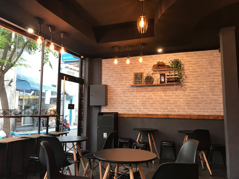 Cozy café interior in Medellín with wooden tables and pendant lights, ideal for remote work