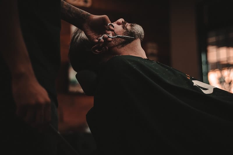 Barber trimming a beard in Colombia — personal care services are excellent and affordable