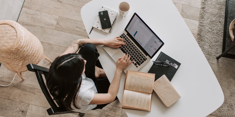 Digital nomad working on laptop from a cafe in Colombia with city view
