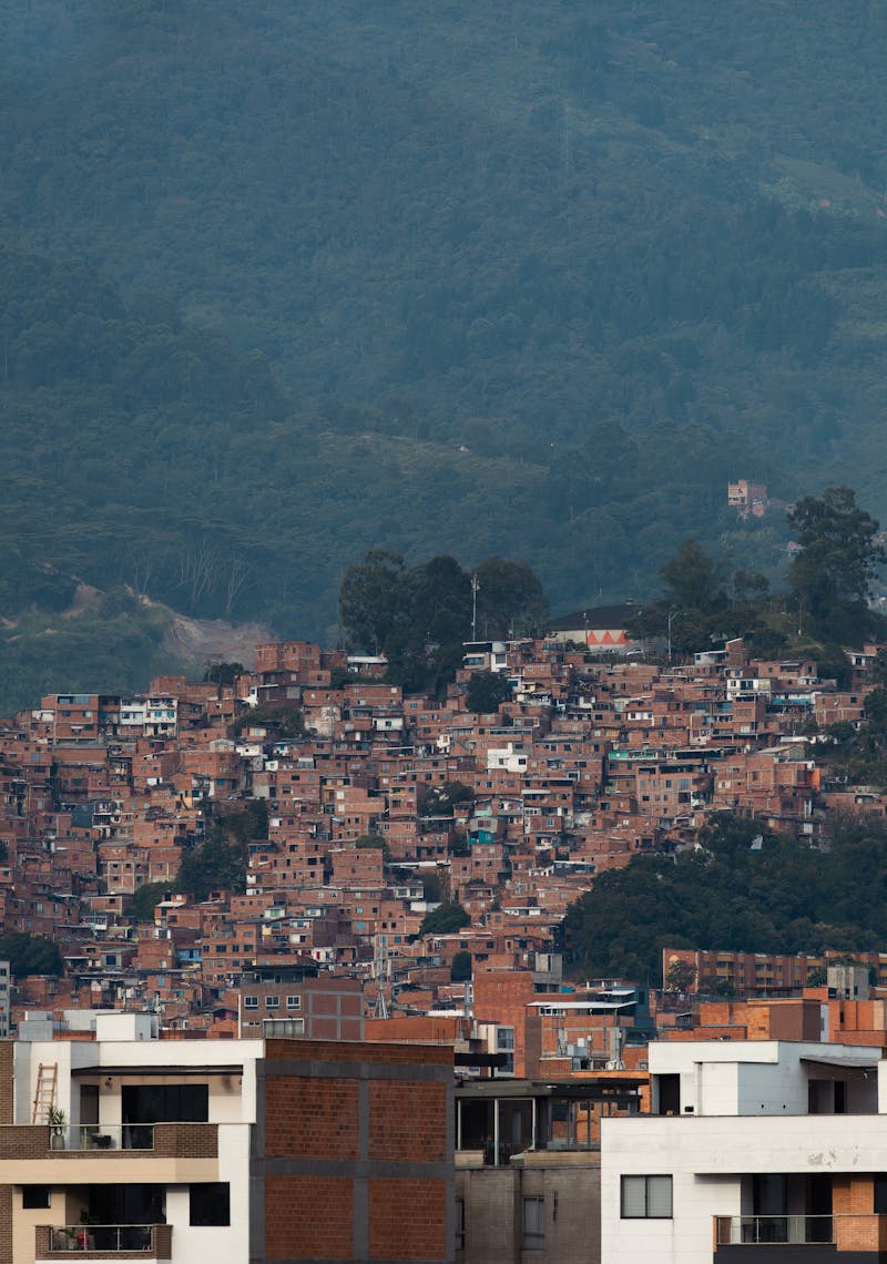 Medellín neighborhood showing contrast between modern apartments and hillside housing, illustrating Colombia's estrato system