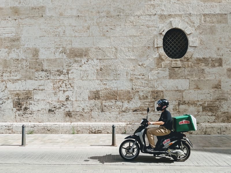 Delivery scooter rider in a city street, representing Colombia's thriving food delivery app scene