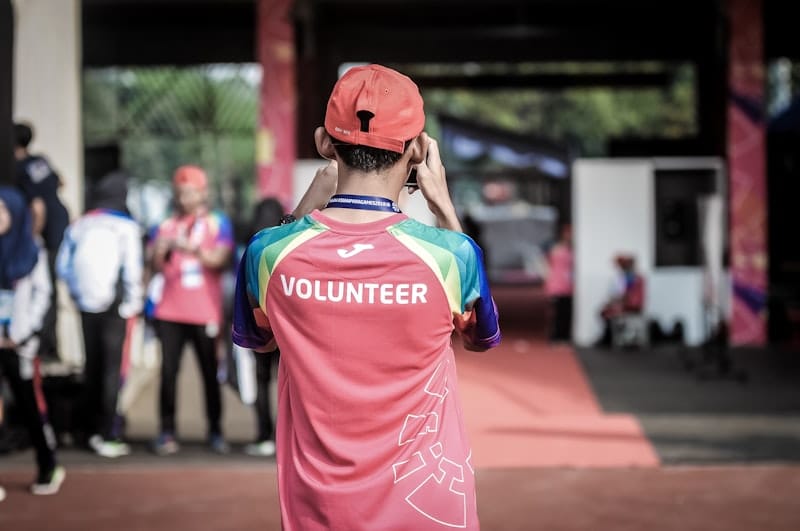 Person wearing a Volunteer shirt at a community event in Colombia