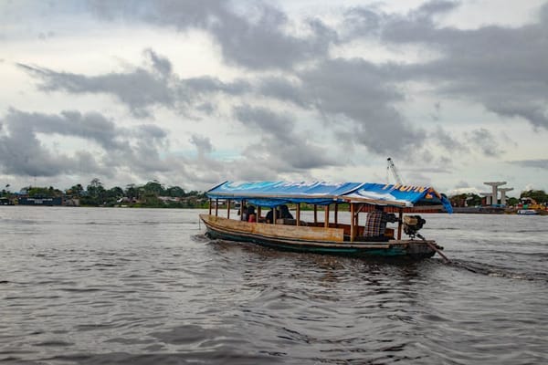 Wooden boat on the Amazon River near Leticia, Colombia at sunset