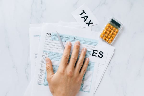 Person filing tax documents at a desk — freelancer taxes in Colombia